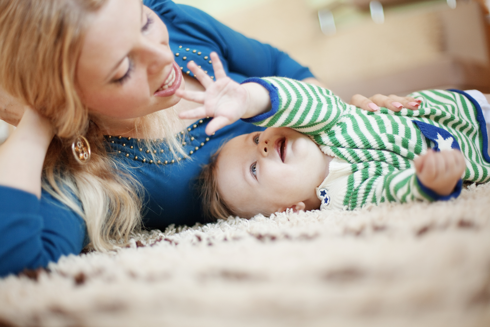 Mother with baby (6-9 months) playing at home, (B&W)