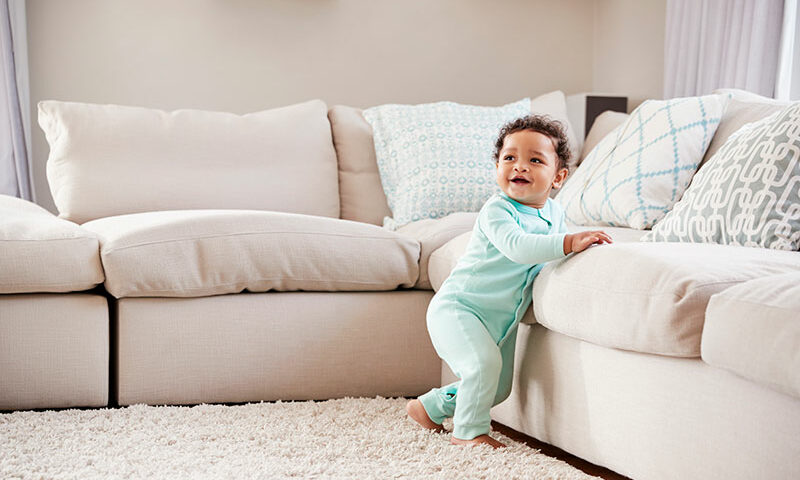 Baby walking around furniture on sale