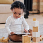 Toddler with tablet and Blocks