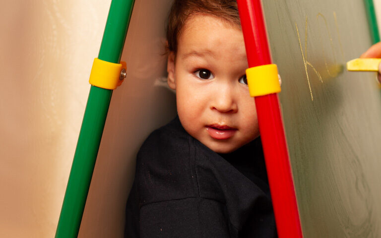 Child Hiding in Calkboard space - may have sensory processing disorder