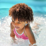 toddler splashing in water